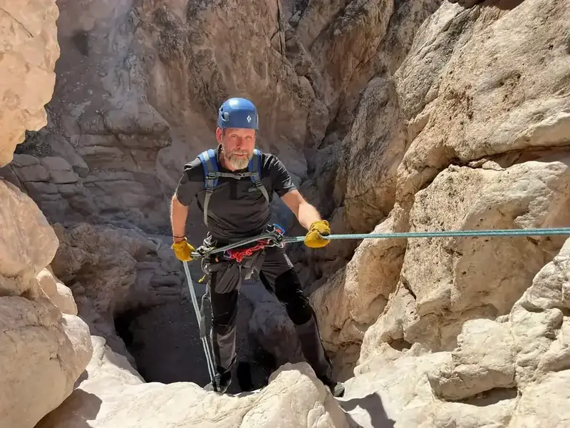 Mark navigating a tight canyon landscape after surgery